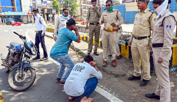 Police personnel punish offenders flouting nationwide lockdown imposed by the government, in the wake of coronavirus pandemic, in Jabalpur, Wednesday, March 25, 2020. Photo: PTI